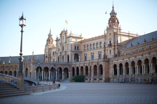 A paved public space in front of the imposing building of Plaza de Espana in Seville