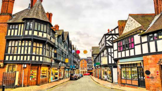 Street in Chester lined with black and white timbered Tudor buildings