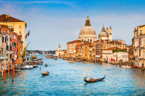 Some gondolas in the canals of Venice on a sunny day