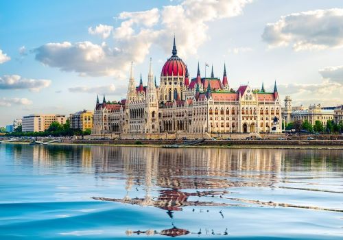 The grand building of the Budapest Parliament reflecting in the Danube river