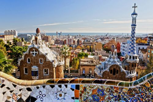 A view of Barcelona city showing buildings and colourful tiles along a wall 