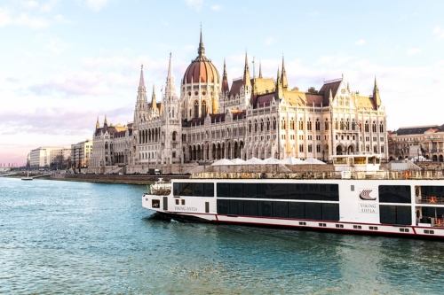 The Viking vessel passing the majestic Hungarian Parliament Building by the river 