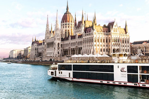 The Viking vessel passing the majestic Hungarian Parliament Building by the river 