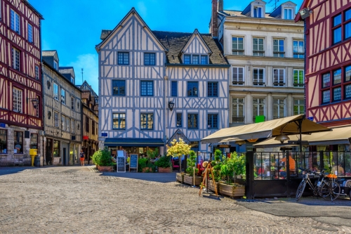 A town square surrounded by pretty half-timbered houses