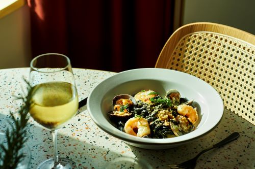 A delicious black seafood pasta arranged on a plate ready to eat