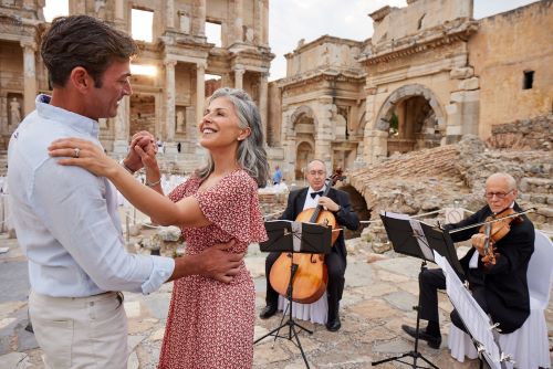 A couple dancing to live music between the monumental ruins of Ephesus 
