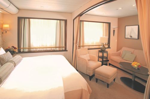 The inside of a Suite with separate bedroom and lounge area and two big windows