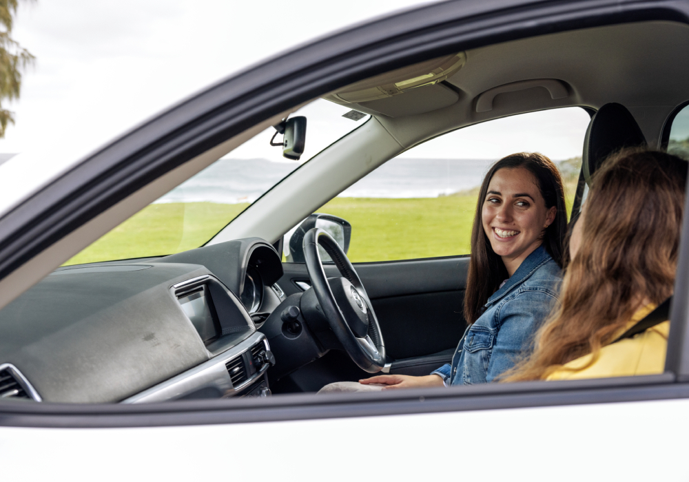 Two girls sitting in a car talking