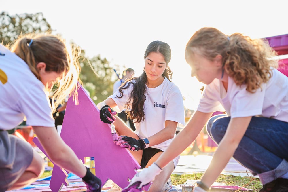 Young people construct purple outdoor furniture at the Mosman Park Better Blocks project