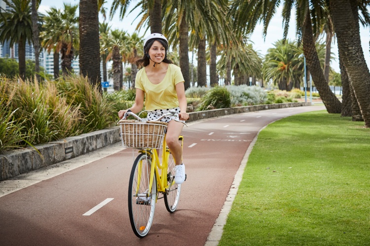 Female riding bike on path