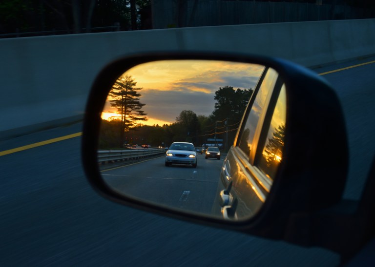 side vision mirror view driving at sunset